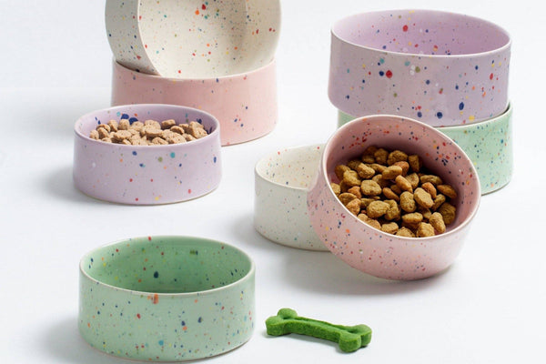 Ceramic dog and puppy bowls, large size in white, pink, purple and green speckles.