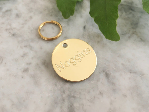 Brass dog or puppy ID tag in luxury solid brass engraved with personalised text in the UK