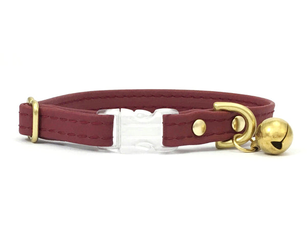 Burgundy cat collar in vegan silicone leather with breakaway buckle and luxury brass bell.