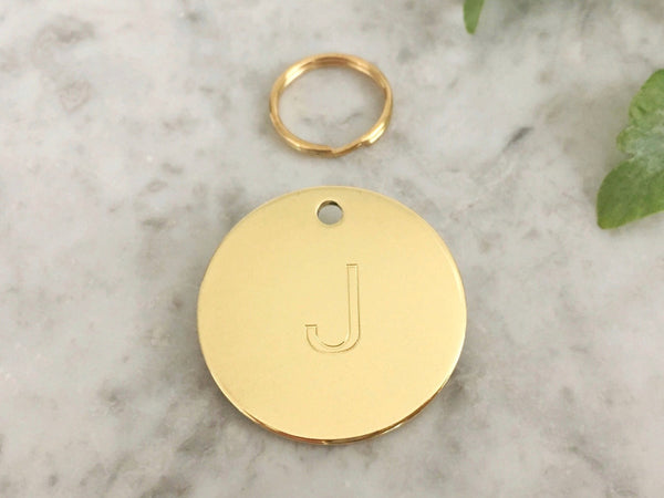 Dog ID tag with initial in luxury solid brass, suitable for dogs and puppies, engraved in the UK.