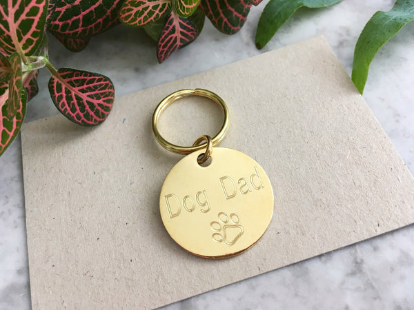 Dog dad gift keyring with cute paw design in luxury brass, personalised in the UK.