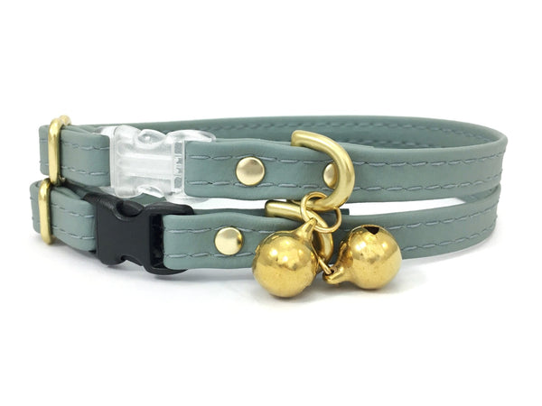 Grey cat collar in vegan silicone leather with breakaway safety buckle and brass bell.
