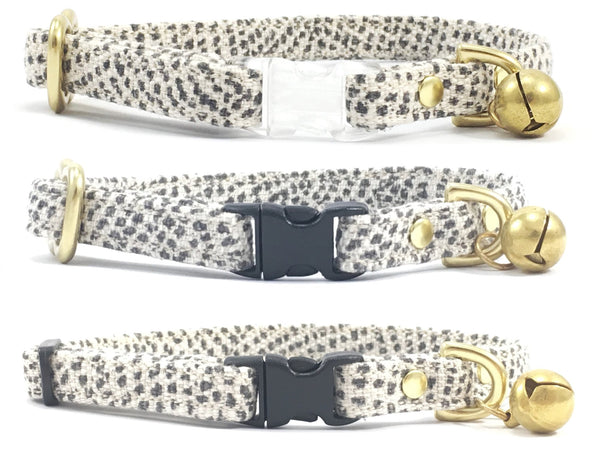 luxury stylish grey polka dot linen and cotton fabric breakaway safety cat collar with solid brass bell, can be customised with a choice of transparent or black breakaway buckle and choice of solid brass or black slider, made by Noggins & Binkles
