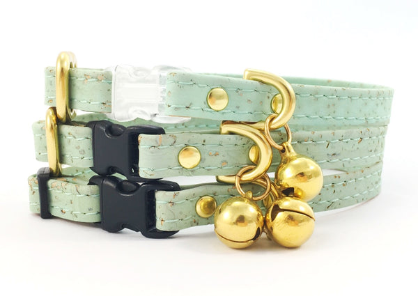 Luxury designer pastel mint green vegan cork 'leather' breakaway safety cat collar with solid brass bell, can be customised with a black or transparent breakaway safety buckle and choice of solid brass or black sliders, made by Noggins & Binkles