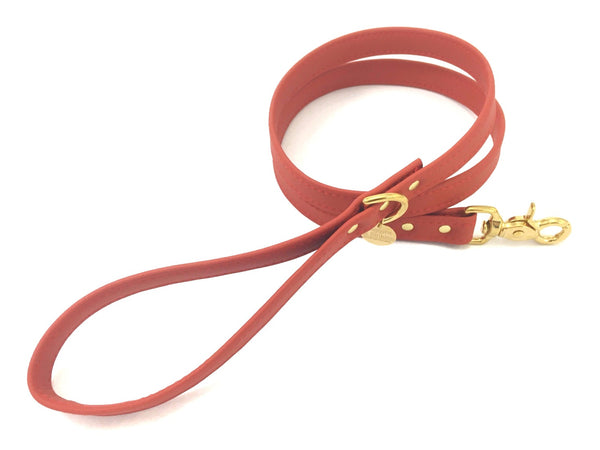 Red vegan silicone leather dog lead in waterproof silicone and luxury brass, made in the UK.