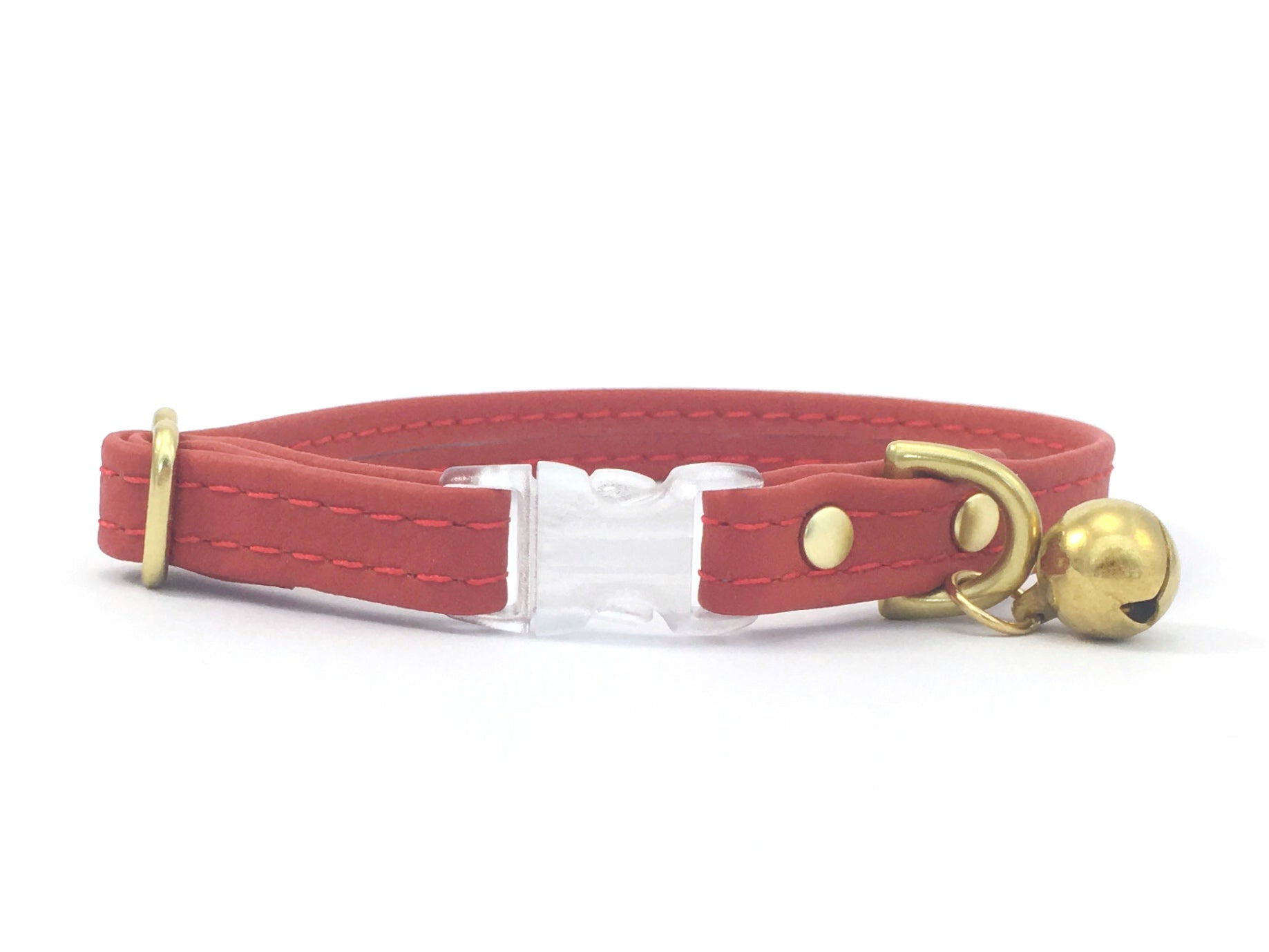 Red cat collar in vegan silicone leather with breakaway buckle and bell, made in the UK.