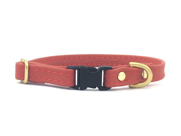 Red silicone miniature dog and puppy collar, suitable for tiny dogs and puppies including toy breeds. Made in vegan leather with luxury brass hardware.