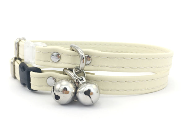 Silicone cat collar in white vegan silicone leather with breakaway safety buckle and silver bell, made in the UK.